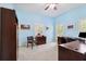 Home office with light blue walls, neutral carpet, two windows with shutters, and dark wood furniture at 2404 W Jetton Ave, Tampa, FL 33629