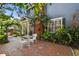 Charming brick patio features an outdoor seating area with lush landscaping at 2404 W Jetton Ave, Tampa, FL 33629