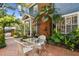 Charming brick patio features an outdoor seating area with lush landscaping at 2404 W Jetton Ave, Tampa, FL 33629