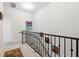 View of the upper level staircase featuring neutral carpet, black iron railing, and art at 2404 W Jetton Ave, Tampa, FL 33629