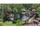 Aerial view of a fenced in pool area with tropical trees at 2439 Madrid Ave, Safety Harbor, FL 34695
