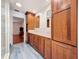 Modern bathroom with wood cabinets, double vanity, and marble-look tile floors at 2439 Madrid Ave, Safety Harbor, FL 34695
