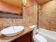 Stylish bathroom featuring a modern vessel sink, custom vanity and tiled shower-tub combination at 2439 Madrid Ave, Safety Harbor, FL 34695