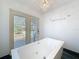 Bathroom highlighting a freestanding soaking tub and views of the outdoor living area at 2439 Madrid Ave, Safety Harbor, FL 34695