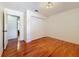 Bedroom featuring hardwood floors, closet and doorway to another room at 2439 Madrid Ave, Safety Harbor, FL 34695