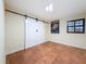 Bedroom showcasing tile flooring, sliding barn doors, and a window at 2439 Madrid Ave, Safety Harbor, FL 34695