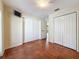 Bright bedroom with tile flooring, double closets and a flat screen tv at 2439 Madrid Ave, Safety Harbor, FL 34695