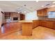 Open kitchen and living room area with wood cabinets, a fireplace, and a kitchen island at 2439 Madrid Ave, Safety Harbor, FL 34695
