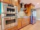 Modern kitchen with stainless steel appliances and wood cabinets with a stone backsplash at 2439 Madrid Ave, Safety Harbor, FL 34695