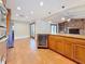 Open floor plan with wood cabinets, wine fridge, a center island, and a fireplace in the living room at 2439 Madrid Ave, Safety Harbor, FL 34695