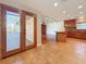 An open kitchen and access to the lanai with a wood deck and a fireplace in the living room at 2439 Madrid Ave, Safety Harbor, FL 34695