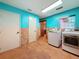 Laundry room with tile flooring, two doors, and updated washer and dryer at 2439 Madrid Ave, Safety Harbor, FL 34695