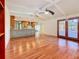 Hardwood floors stretch between the kitchen and living room, with lanai access and lots of natural light at 2439 Madrid Ave, Safety Harbor, FL 34695