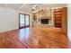Living room and dining room include hardwood floors, a brick fireplace, built-in shelves, and lanai access at 2439 Madrid Ave, Safety Harbor, FL 34695