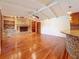Open living room with wood floors, a fireplace, and access to the kitchen with a center island at 2439 Madrid Ave, Safety Harbor, FL 34695