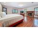 Spacious main bedroom with hardwood floors, fireplace, and ample natural light at 2439 Madrid Ave, Safety Harbor, FL 34695