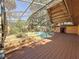 Inviting pool area featuring a screened enclosure, wood decking, and ample space for outdoor entertaining at 2439 Madrid Ave, Safety Harbor, FL 34695