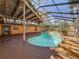 Pool featuring a screened enclosure, wood decking, and well-designed steps for easy access at 2439 Madrid Ave, Safety Harbor, FL 34695