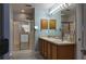 Bright bathroom with a double vanity, a large mirror, and a glass-enclosed shower at 270 Planter Rd, Spring Hill, FL 34606