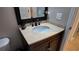 Bathroom vanity with dark wood cabinets, light countertops, and decorative black faucet at 270 Planter Rd, Spring Hill, FL 34606