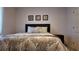Bedroom with decorative headboard, patterned bedding, and matching nightstand at 270 Planter Rd, Spring Hill, FL 34606