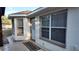 Exterior patio features a covered area and multiple windows, adding natural light and charm at 270 Planter Rd, Spring Hill, FL 34606