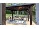 Gazebo with ambient lighting, table with chairs, and fire pit creates a relaxing outdoor space at 270 Planter Rd, Spring Hill, FL 34606