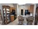 Traditional kitchen with wooden cabinets, black appliances, and a breakfast bar with ornate bar stools at 270 Planter Rd, Spring Hill, FL 34606