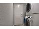 Convenient laundry area with stacked washer and dryer, next to the back door to the outside at 270 Planter Rd, Spring Hill, FL 34606