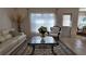 Living room with a glass coffee table and elegant seating, bathed in natural light at 270 Planter Rd, Spring Hill, FL 34606