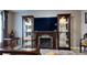 Living room showcasing a fireplace with display cabinets and a glass coffee table at 270 Planter Rd, Spring Hill, FL 34606