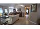 Open living room with elegant decor, tile flooring, and multiple seating areas at 270 Planter Rd, Spring Hill, FL 34606