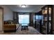 Bright living room with large window, fireplace, display case, and comfortable seating at 270 Planter Rd, Spring Hill, FL 34606