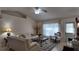 Cozy living room featuring white couches, a ceiling fan and a glass coffee table at 270 Planter Rd, Spring Hill, FL 34606
