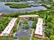 Aerial view of condo buildings showcasing ample parking and beautifully maintained grounds at 2700 Bayshore Blvd # 544, Dunedin, FL 34698