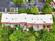 Aerial of the condos featuring the white roofs, patios, landscaping, assigned parking, and visitor parking at 2700 Bayshore Blvd # 544, Dunedin, FL 34698