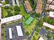 Community aerial view featuring a tennis court, pool, and covered parking spaces at 2700 Bayshore Blvd # 544, Dunedin, FL 34698
