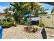 Charming brick patio with outdoor seating, potted plants and a tropical palm tree centerpiece at 2700 Bayshore Blvd # 544, Dunedin, FL 34698