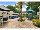 Brick patio featuring outdoor seating areas, lush plants and tasteful decor with a privacy fence at 2700 Bayshore Blvd # 544, Dunedin, FL 34698