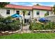 Fenced backyard featuring a garden with flowers, greenery, and access to the property at 2700 Bayshore Blvd # 544, Dunedin, FL 34698