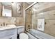 Tiled bathroom featuring a shower-tub combo with glass doors and a neutral color scheme at 2700 Bayshore Blvd # 544, Dunedin, FL 34698