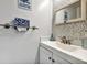 Modern half-bathroom with stylish fixtures, decorative mirror, and convenient storage, perfect for guests at 2700 Bayshore Blvd # 544, Dunedin, FL 34698