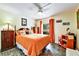 Bedroom with a warm color palette, featuring a ceiling fan, wooden furniture, and wood-look flooring at 2700 Bayshore Blvd # 544, Dunedin, FL 34698