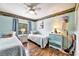 Cozy bedroom with twin beds, ceiling fan, blue accents, and wood-look flooring at 2700 Bayshore Blvd # 544, Dunedin, FL 34698