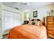 Bedroom featuring warm colors, ceiling fan, closet, and wood-look flooring at 2700 Bayshore Blvd # 544, Dunedin, FL 34698