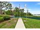 Serene community space featuring flag poles, lush landscaping, and bay views at 2700 Bayshore Blvd # 544, Dunedin, FL 34698