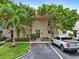 Charming condo with well-maintained landscaping, a red tile roof, and assigned parking in front of the unit at 2700 Bayshore Blvd # 544, Dunedin, FL 34698