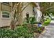 Townhouse exterior featuring a well-manicured lawn, mature trees and flowering shrubs at 2700 Bayshore Blvd # 544, Dunedin, FL 34698