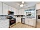 Bright kitchen with white cabinets, stainless steel appliances, and light wood-look flooring at 2700 Bayshore Blvd # 544, Dunedin, FL 34698