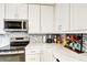 Updated kitchen featuring white cabinets, stainless steel appliances, and stylish countertops at 2700 Bayshore Blvd # 544, Dunedin, FL 34698